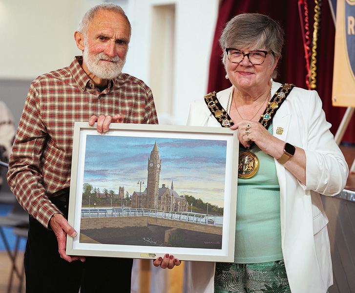 Mayor Janet Emsley presents Colin Robinson with a fine painting of Rochdale Town Hall